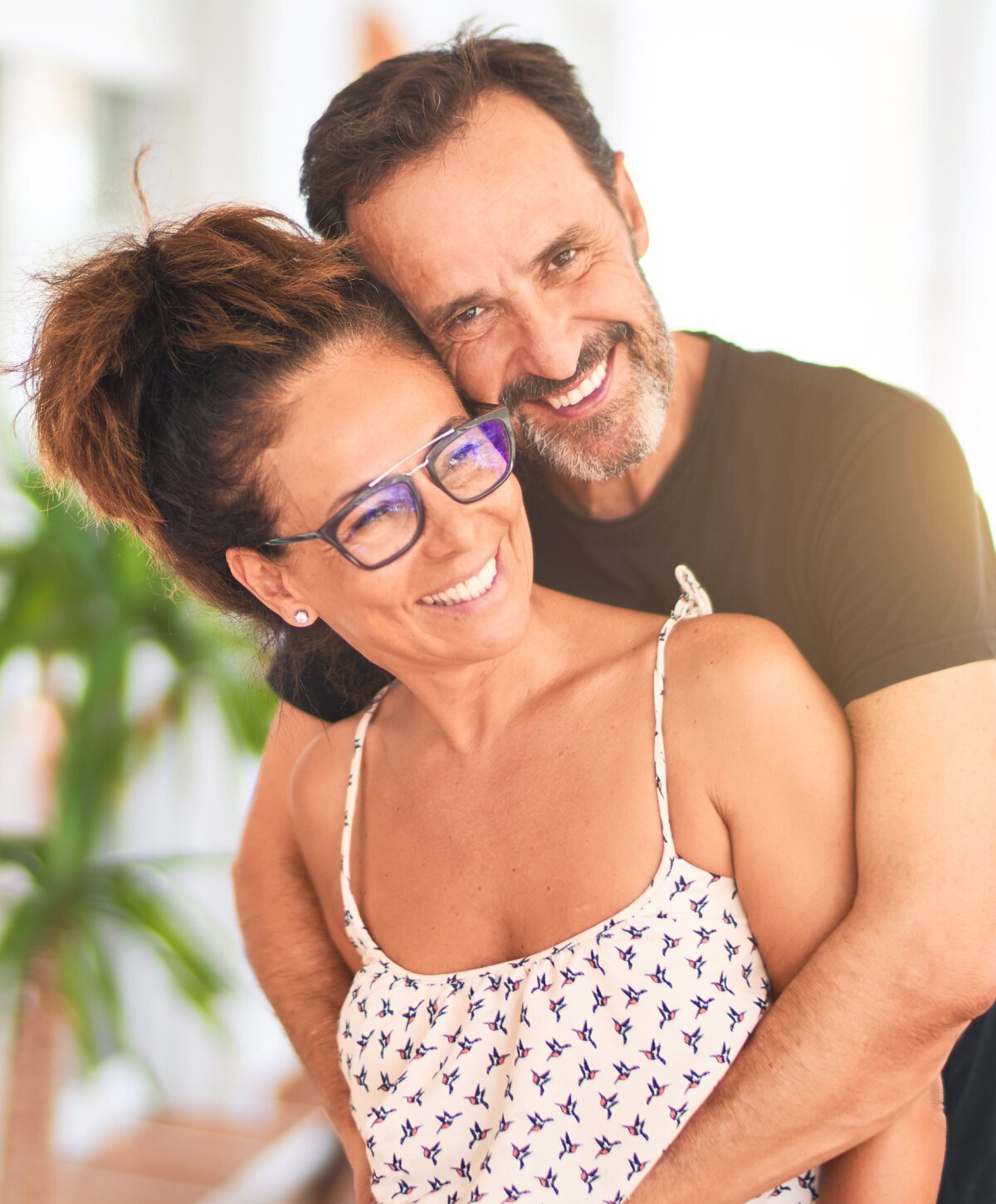 dental implant patient models couple smiling and embracing