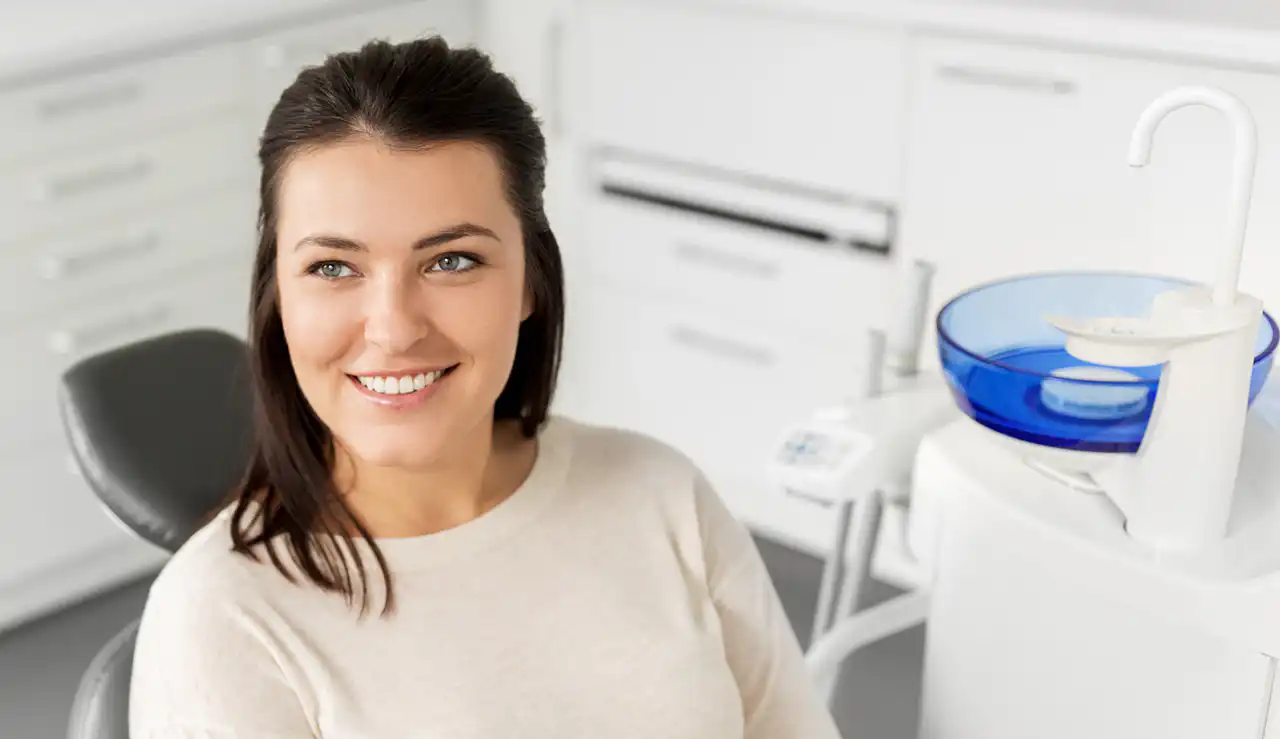 Smiling woman seated in a modern dental clinic